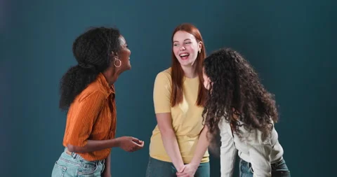 Three girls of different ethnicities smiling and laughing Stock Footage 134450771