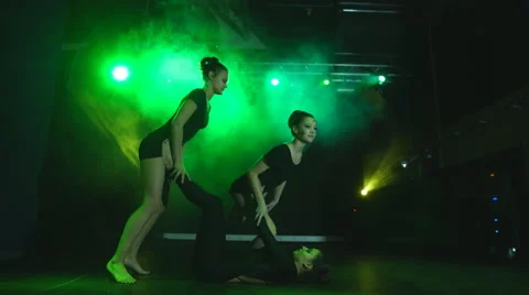 Three girls doing acrobatic Stock Footage 66876585