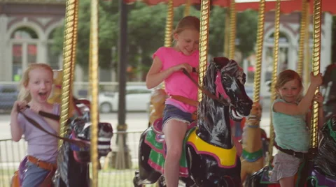 Three girls riding on a carousel Vidéo 55532836