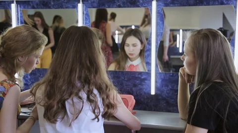 Three girls sit in front of mirror and happily talk with each other Video stock 67819735