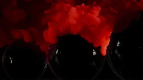 Three glass balls and red paint splash flowing on them. Stock Footage 115596253