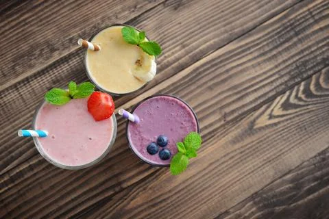 Three glass of fruit milkshakes Stock Photos
