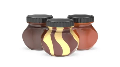 Three glass jars with different hazelnut cocoa spreads Stock Footage 296628821