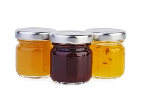 Three glass jars with different jam Foto stock
