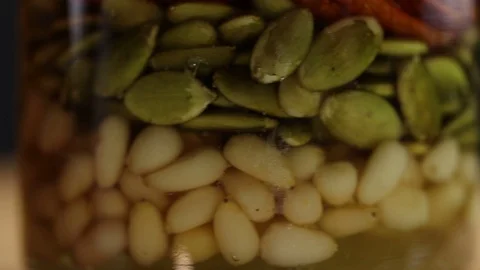 Three glass jars with a mixture of nuts Stock Footage 124829742