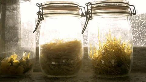 Three glass jars with paste in a window. tracking shot Stock Footage 78175522