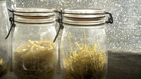 Three glass jars with paste in a window. Pan Stock Footage 78175542