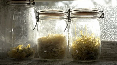 Three glass jars with paste in a window. tracking shot 스톡 동영상 78175571