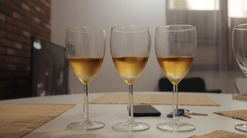 Three glasses of champagne on the table in the kitchen closeup Stock Footage 111698268