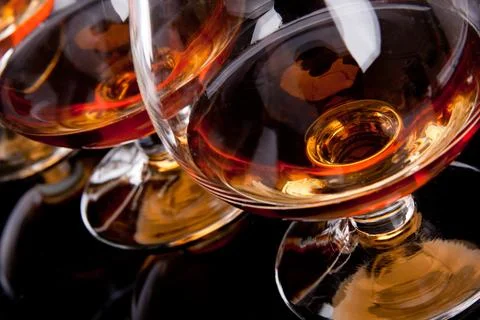 Three glasses of cognac in a row Stock Photos