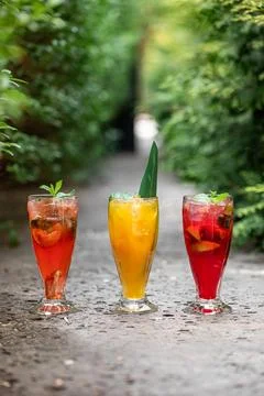 Three glasses of different fruit fresh lemonades Stock Photos