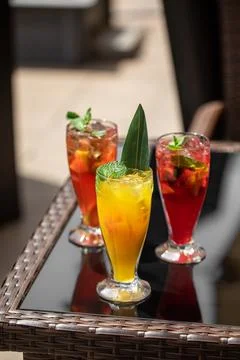 Three glasses of different fruit fresh lemonades Stock Photos