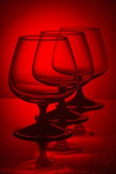 Three glasses in red light Stock Photos