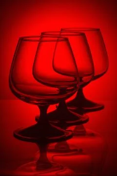 Three glasses in red light Stock Photos