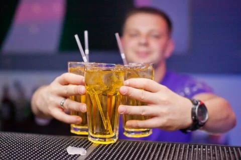 Three glasses with a refreshing drink on bar counter Stock Photos