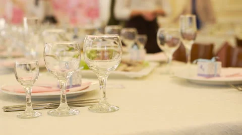Three glasses on table at restaurant and waiters at background Stock Footage 68025534