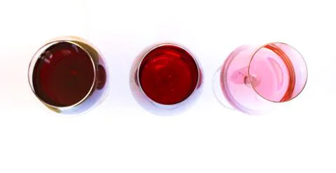 Three glasses of wine: red and pink on white background with sparkling shadow Stock Photos