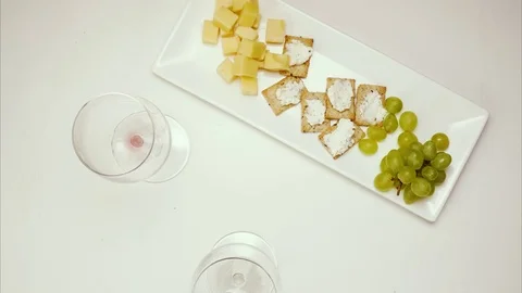 Three glasses of wine, red, pink and white, on the table with a snack dish. Stop Stock Footage 73771127