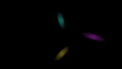 Three glowing elliptical shapes rotating in a dark void at slow speed Video stock 335117562