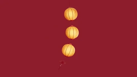Three glowing paper lanterns sway gently against deep red background festiv.. Vídeos de archivo 332336687