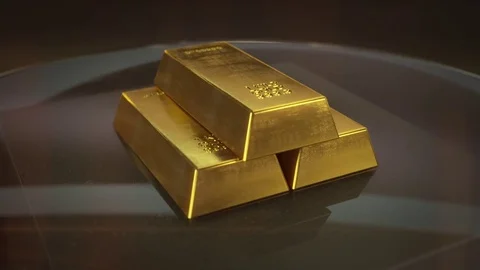 Three Gold Bricks on Glass Table which Rotates 360 Degrees. Stock Footage 81187927