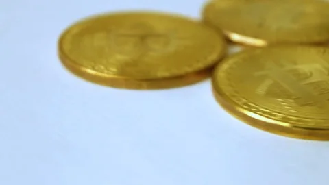 Three gold coins bitcoins, spinning on white background Stock Footage 86983621
