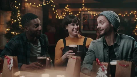 Three Good Friends having a Christmas beers together in a bar Stock Footage 132016803