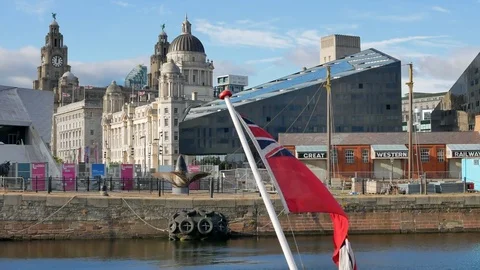 Three Graces Seen Across Canning Dock and the Flag, Liverpool, United Kingdom Stock Footage 83491443