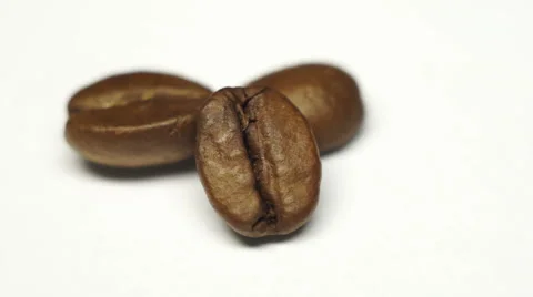 Three grains of coffee close-up on white background. Rotation view Stock Footage 45159647