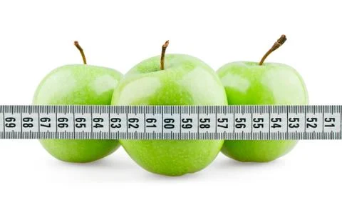 Three green apples behind meter Stock Photos