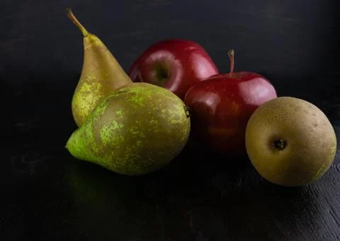 Three green pears and two red apples Stock Photos