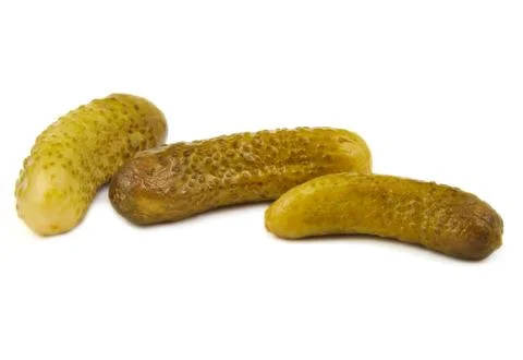 Three green pickles on white background Foto stock