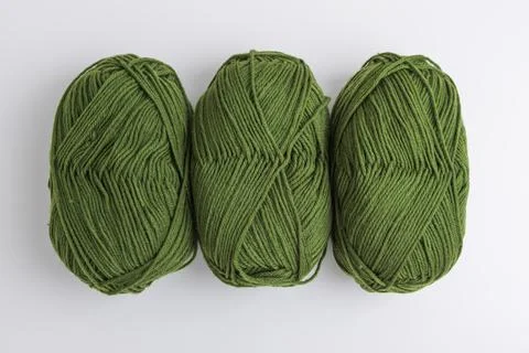Three green wool yarn balls for knitting and crochet hobbies Stock Photos