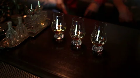 Three grown men take the glasses with whiskey. Close-up Stock Footage 64581551
