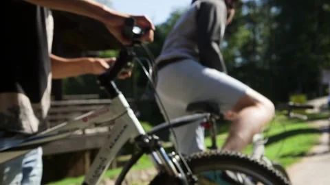 Three Guys Pick Up Parked Bikes and Ride Them Away Stock Footage 265129942