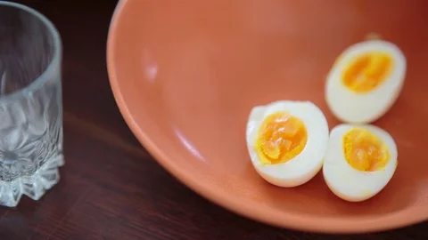 Three half boiled eggs in the plate Vídeos de archivo 94881724