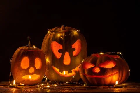 Three halloween jack o lantern pumpkins Stock Photos