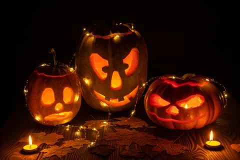 Three halloween jack o lantern pumpkins Stock Photos
