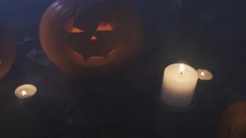 Three Halloween Pumpkins head lantern with burning candles on a black background Stock Footage 80251673