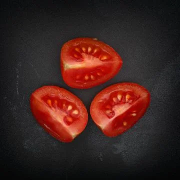 Three halves of cherry tomato Stock Photos