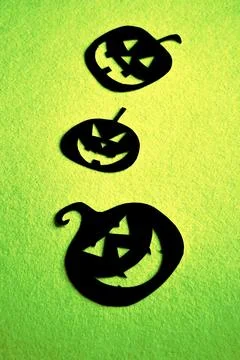 Three hand-painted black pumpkins on a green background Stock Photos
