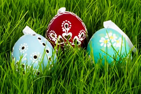 Three hand painted easter eggs in grass Stock Photos