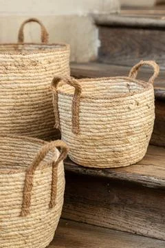 Three Handmade Woven Wicker Baskets on Rustic Wooden Stairs Stock Photos