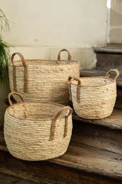 Three Handmade Woven Wicker Baskets on Rustic Wooden Stairs Stock Photos