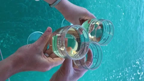 Three hands holding glasses with white wine Stock Footage 157316869