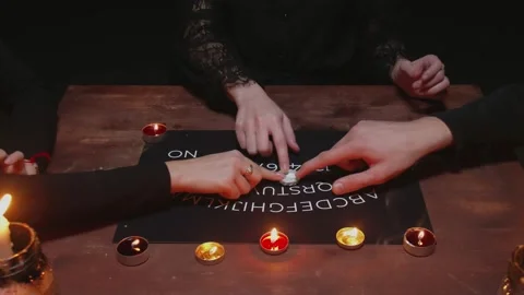 Three hands uses Ouija Board Spirit Game Stock Footage 145690735