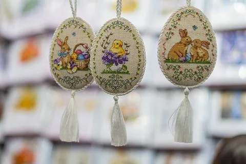 Three hanging, intricately designed Easter eggs with spring and holiday the.. Stock Photos