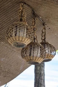 Three hanging lanterns with a wicker frame 스톡 사진