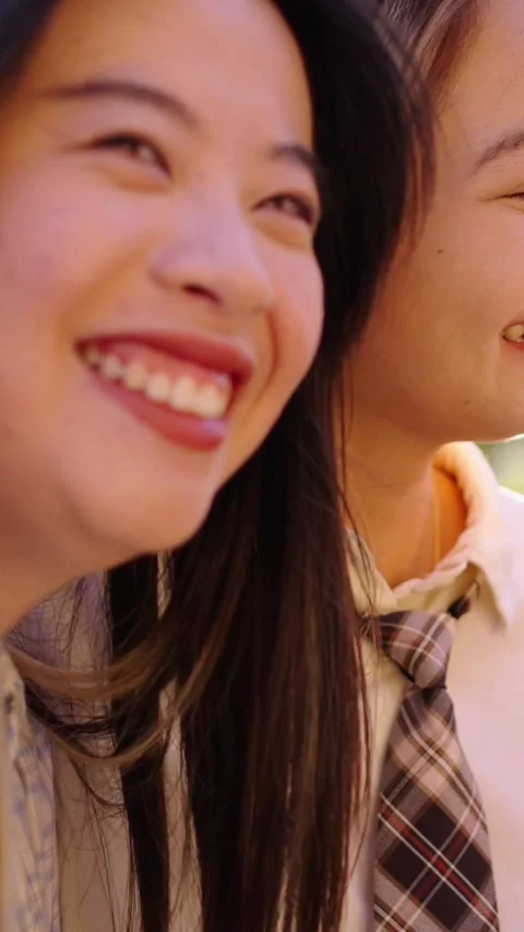 Three happy and joyful young Asian beautiful women embracing and looking Stock Footage 266608910