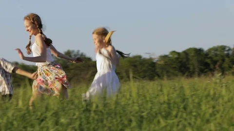 Three happy children playing in the field at the day time. Stock Footage 79197092